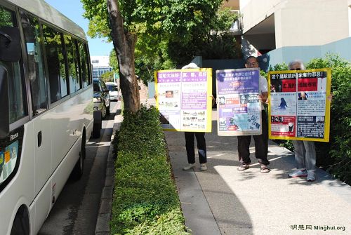 法輪功學員在澳洲布里斯本中國城舉展板，向中國遊客講真相。